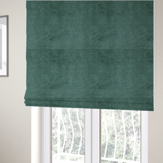 The fabric used to create these Roman blinds is a deep, rich teal or blue-green upholstery fabric. It maintains the signature dense, uniform, boucle-style weave of the collection, composed of small, looped, and nubby yarn fibres that create a soft and tactile surface.