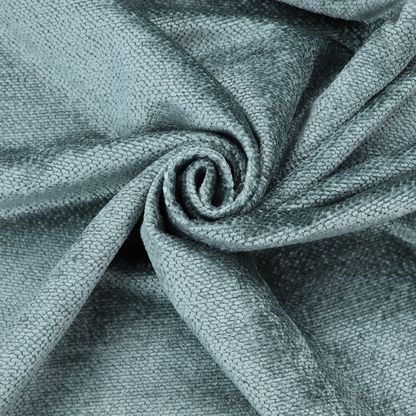 A cool, muted blue or slate-toned upholstery fabric. It features the same signature dense, uniform, boucle-style weave as the previous samples, characterized by small, looped, and nubby yarn fibres that create a soft and tactile surface.