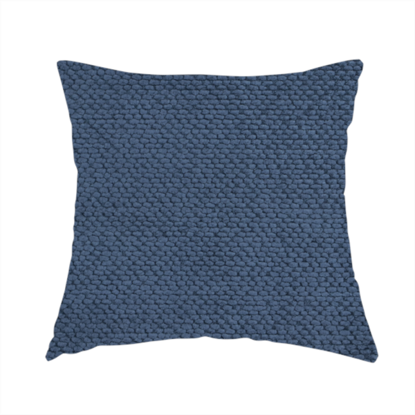The fabric used to create this handmade cushion is a deep, rich navy blue upholstery fabric. It features the signature dense, uniform, boucle-style weave of the collection, composed of small, looped, and nubby yarn fibres that create a soft and tactile surface.
