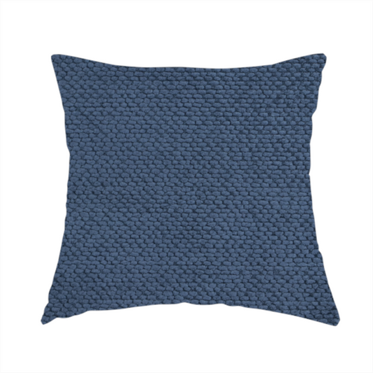 The fabric used to create this handmade cushion is a deep, rich navy blue upholstery fabric. It features the signature dense, uniform, boucle-style weave of the collection, composed of small, looped, and nubby yarn fibres that create a soft and tactile surface.
