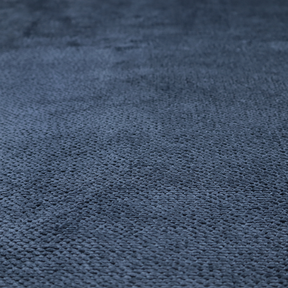A deep, rich navy blue upholstery fabric. It features the signature dense, uniform, boucle-style weave of the collection, composed of small, looped, and nubby yarn fibres that create a soft and tactile surface.