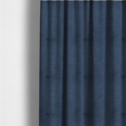 The fabric used to create these made-to-measure curtains is a deep, rich navy blue upholstery fabric. It features the signature dense, uniform, boucle-style weave of the collection, composed of small, looped, and nubby yarn fibres that create a soft and tactile surface.