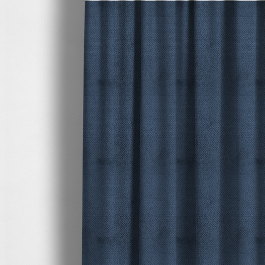 The fabric used to create these made-to-measure curtains is a deep, rich navy blue upholstery fabric. It features the signature dense, uniform, boucle-style weave of the collection, composed of small, looped, and nubby yarn fibres that create a soft and tactile surface.