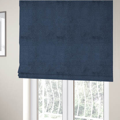 The fabric used to create these Roman blinds is a deep, rich navy blue upholstery fabric. It features the signature dense, uniform, boucle-style weave of the collection, composed of small, looped, and nubby yarn fibres that create a soft and tactile surface.
