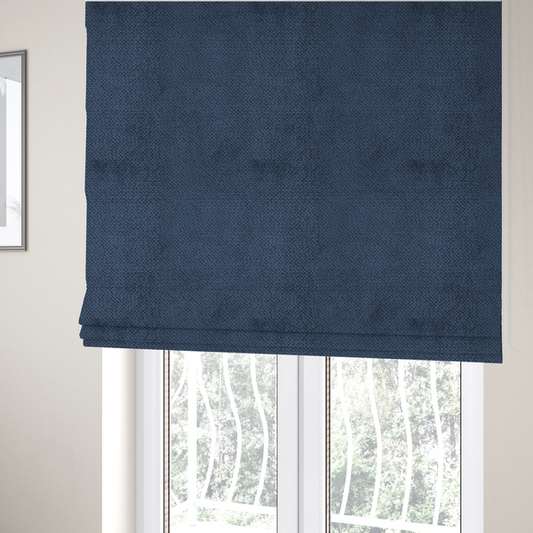 The fabric used to create these Roman blinds is a deep, rich navy blue upholstery fabric. It features the signature dense, uniform, boucle-style weave of the collection, composed of small, looped, and nubby yarn fibres that create a soft and tactile surface.