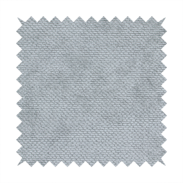 A soft, light-toned, cool-grey upholstery fabric. It features the signature dense, uniform, boucle-style weave of the collection, created with small, looped, and nubby yarn fibres that offer a comfortable, tactile surface.
