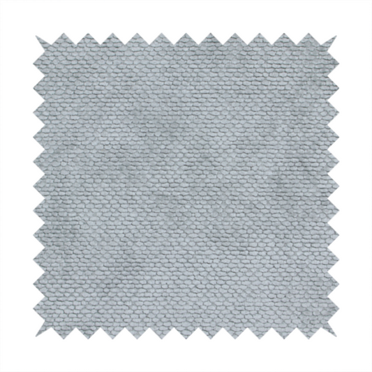 A soft, light-toned, cool-grey upholstery fabric. It features the signature dense, uniform, boucle-style weave of the collection, created with small, looped, and nubby yarn fibres that offer a comfortable, tactile surface.