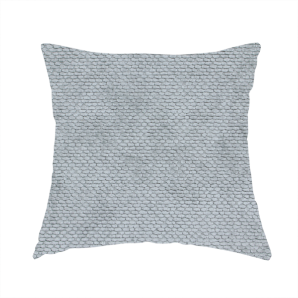 The fabric used to create this handmade cushion is a soft, light-toned, cool-grey upholstery fabric. It features the signature dense, uniform, boucle-style weave of the collection, created with small, looped, and nubby yarn fibres that offer a comfortable, tactile surface.