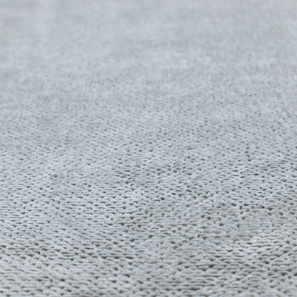 A soft, light-toned, cool-grey upholstery fabric. It features the signature dense, uniform, boucle-style weave of the collection, created with small, looped, and nubby yarn fibres that offer a comfortable, tactile surface.