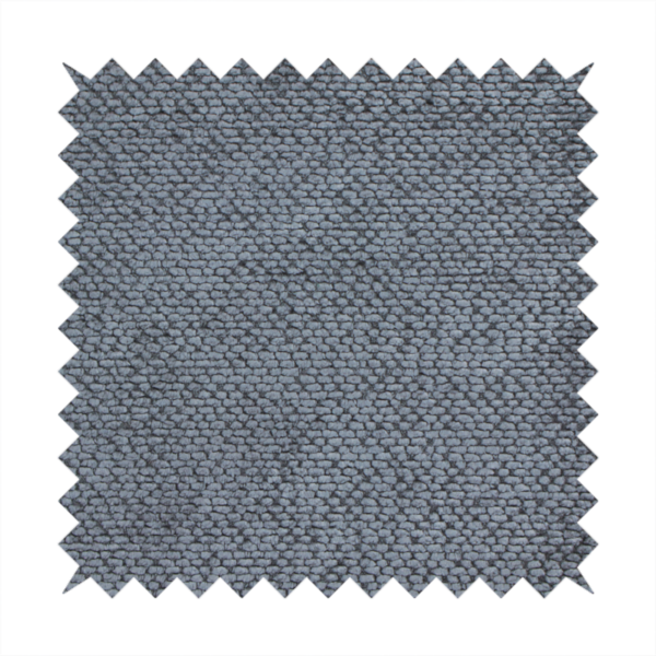 A deep, moody charcoal or slate-grey upholstery fabric. It maintains the signature dense, uniform, boucle-style weave of the collection, composed of small, looped, and nubby yarn fibres that provide a soft and tactile surface.