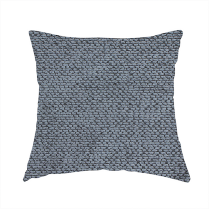 The fabric used to create this handmade cushion is a deep, moody charcoal or slate-grey upholstery fabric. It maintains the signature dense, uniform, boucle-style weave of the collection, composed of small, looped, and nubby yarn fibres that provide a soft and tactile surface.