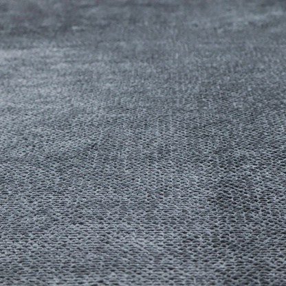 A deep, moody charcoal or slate-grey upholstery fabric. It maintains the signature dense, uniform, boucle-style weave of the collection, composed of small, looped, and nubby yarn fibres that provide a soft and tactile surface.