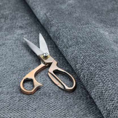 A deep, moody charcoal or slate-grey upholstery fabric. It maintains the signature dense, uniform, boucle-style weave of the collection, composed of small, looped, and nubby yarn fibres that provide a soft and tactile surface.