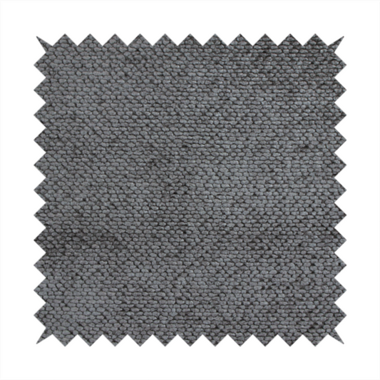 A deep, dark grey or graphite-toned upholstery fabric. It features the signature dense, uniform, boucle-style weave of the collection, composed of small, looped, and nubby yarn fibres that create a soft and tactile surface.