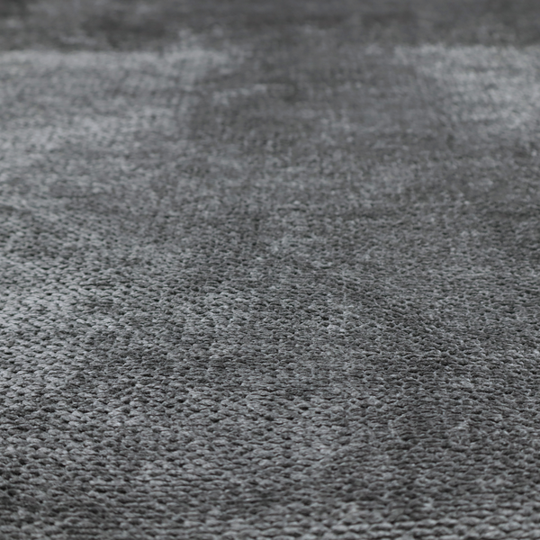 A deep, dark grey or graphite-toned upholstery fabric. It features the signature dense, uniform, boucle-style weave of the collection, composed of small, looped, and nubby yarn fibres that create a soft and tactile surface.