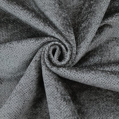 A deep, dark grey or graphite-toned upholstery fabric. It features the signature dense, uniform, boucle-style weave of the collection, composed of small, looped, and nubby yarn fibres that create a soft and tactile surface.