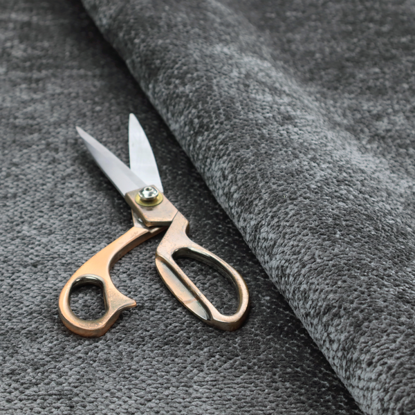 A deep, dark grey or graphite-toned upholstery fabric. It features the signature dense, uniform, boucle-style weave of the collection, composed of small, looped, and nubby yarn fibres that create a soft and tactile surface.
