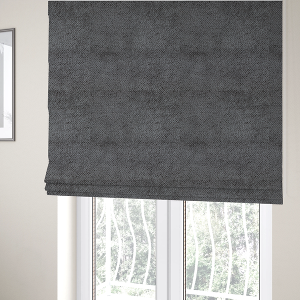 The fabric used to create these Roman blinds is a deep, dark grey or graphite-toned upholstery fabric. It features the signature dense, uniform, boucle-style weave of the collection, composed of small, looped, and nubby yarn fibres that create a soft and tactile surface.