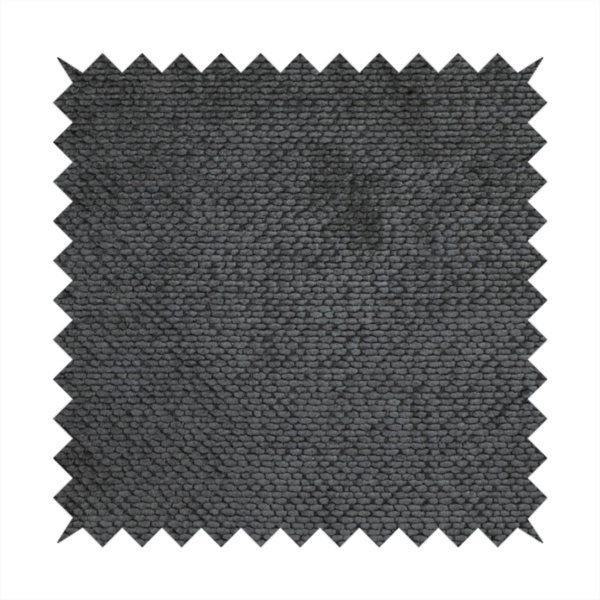 A deep, dark charcoal or near-black upholstery fabric. It maintains the signature dense, uniform, boucle-style weave of the collection, characterized by small, looped, and nubby yarn fibres that provide a soft and tactile surface.