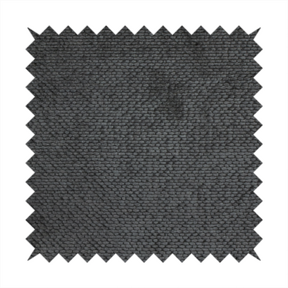 A deep, dark charcoal or near-black upholstery fabric. It maintains the signature dense, uniform, boucle-style weave of the collection, characterized by small, looped, and nubby yarn fibres that provide a soft and tactile surface.