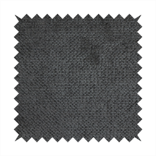 A deep, dark charcoal or near-black upholstery fabric. It maintains the signature dense, uniform, boucle-style weave of the collection, characterized by small, looped, and nubby yarn fibres that provide a soft and tactile surface.