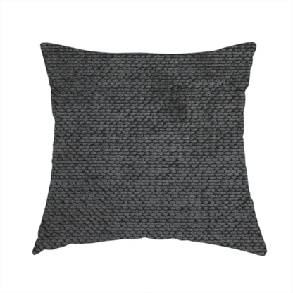 The fabric used to create this handmade cushion is a deep, dark charcoal or near-black upholstery fabric. It maintains the signature dense, uniform, boucle-style weave of the collection, characterized by small, looped, and nubby yarn fibres that provide a soft and tactile surface.