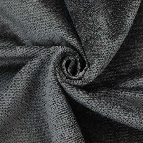 A deep, dark charcoal or near-black upholstery fabric. It maintains the signature dense, uniform, boucle-style weave of the collection, characterized by small, looped, and nubby yarn fibres that provide a soft and tactile surface.