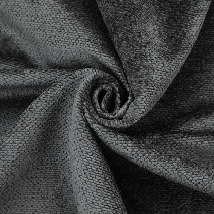 A deep, dark charcoal or near-black upholstery fabric. It maintains the signature dense, uniform, boucle-style weave of the collection, characterized by small, looped, and nubby yarn fibres that provide a soft and tactile surface.
