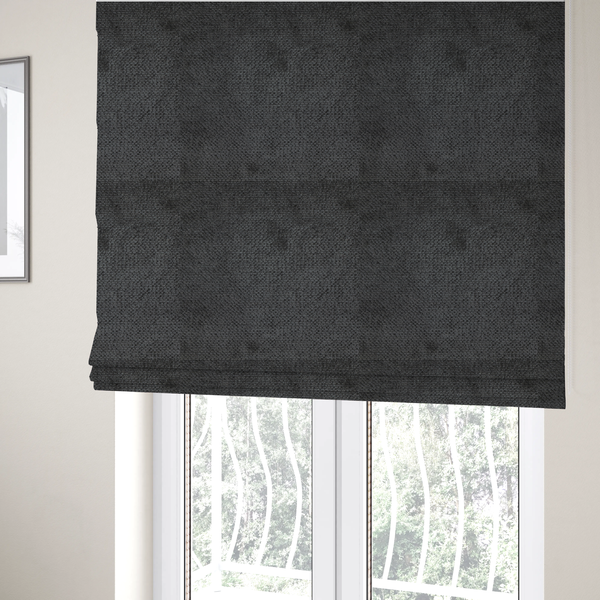 The fabric used to create these Roman blinds is a deep, dark charcoal or near-black upholstery fabric. It maintains the signature dense, uniform, boucle-style weave of the collection, characterized by small, looped, and nubby yarn fibres that provide a soft and tactile surface.