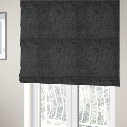 The fabric used to create these Roman blinds is a deep, dark charcoal or near-black upholstery fabric. It maintains the signature dense, uniform, boucle-style weave of the collection, characterized by small, looped, and nubby yarn fibres that provide a soft and tactile surface.