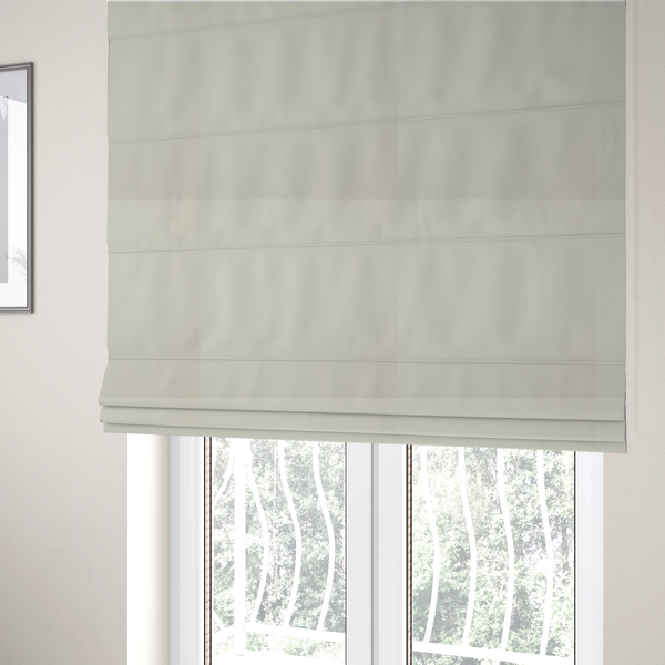 The fabric used to create these Roman blinds is a solid pearl-coloured fabric texture with a fine, smooth weave.