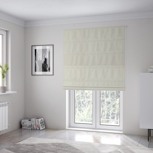 The fabric used to create these Roman blinds is a solid pearl-coloured fabric texture with a fine, smooth weave.
