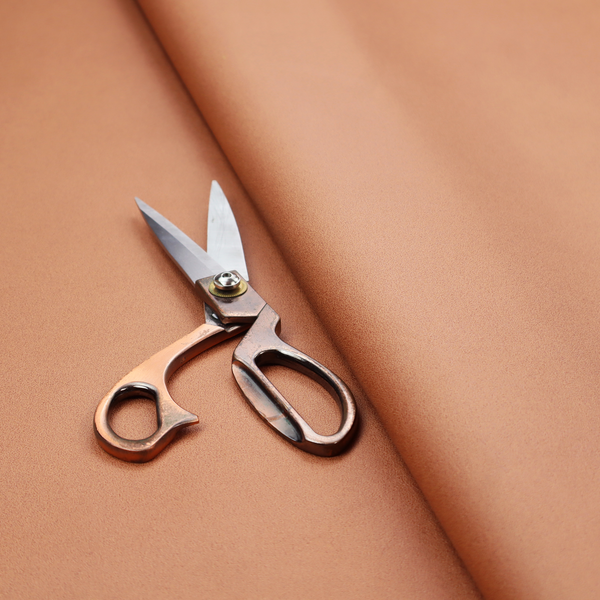 A solid orange-coloured Hallstatt faux leather fabric texture with a smooth, fine finish.