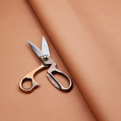 A solid orange-coloured Hallstatt faux leather fabric texture with a smooth, fine finish.