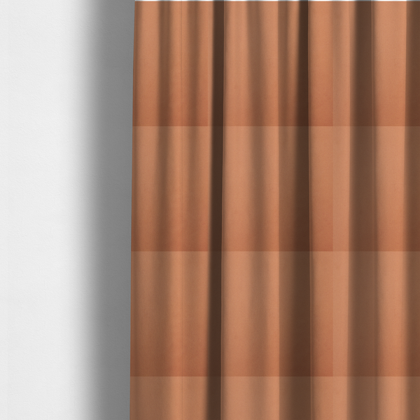 The fabric used to create these made-to-measure curtains is a solid orange-coloured Hallstatt faux leather fabric texture with a smooth, fine finish.