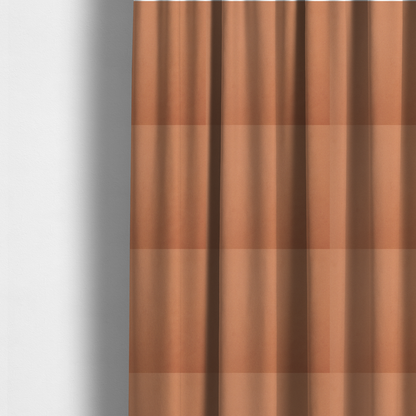 The fabric used to create these made-to-measure curtains is a solid orange-coloured Hallstatt faux leather fabric texture with a smooth, fine finish.