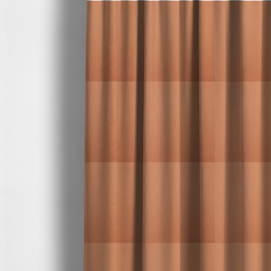 The fabric used to create these made-to-measure curtains is a solid orange-coloured Hallstatt faux leather fabric texture with a smooth, fine finish.