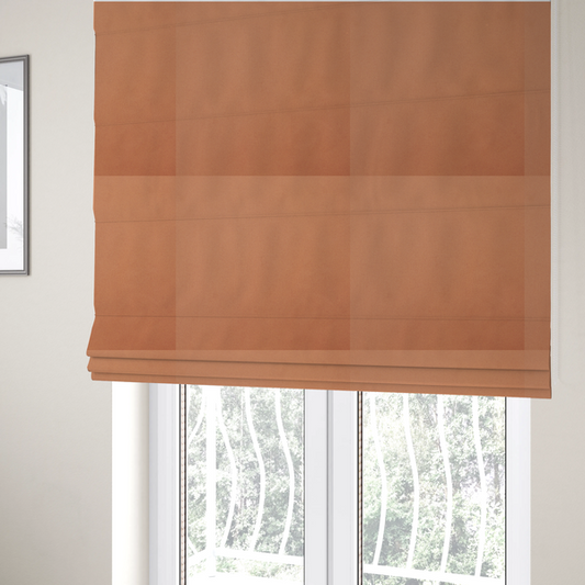 The fabric used to create these Roman blinds is a solid orange-coloured Hallstatt faux leather fabric texture with a smooth, fine finish.