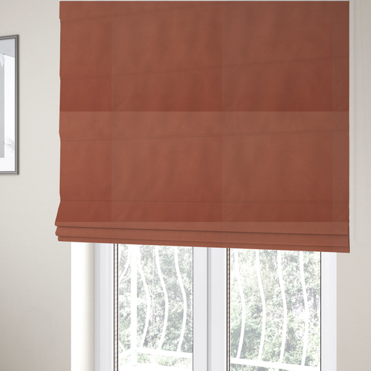 The fabric used to create these Roman blinds is a solid rust-coloured Hallstatt faux leather fabric texture with a smooth, fine finish.
