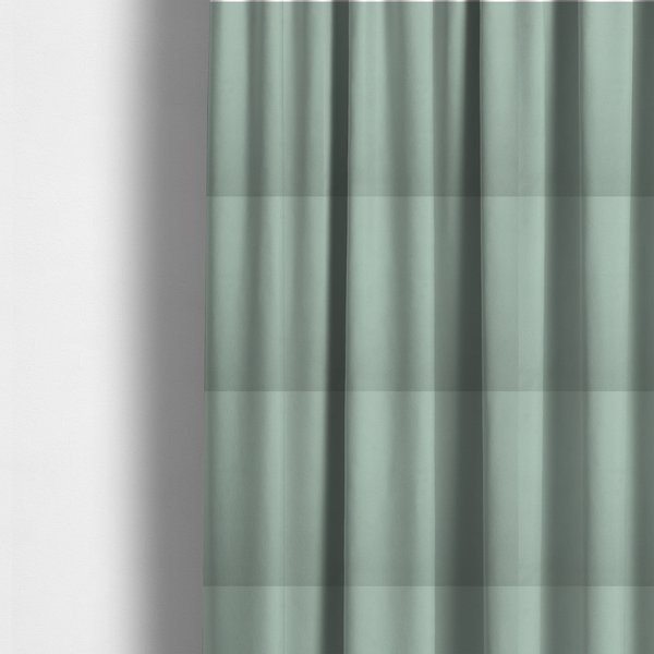 The fabric used to create these made-to-measure curtains is a solid sage green-coloured Hallstatt faux leather fabric texture with a smooth, fine finish.