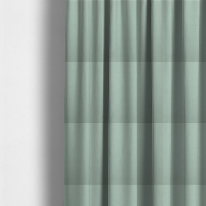 The fabric used to create these made-to-measure curtains is a solid sage green-coloured Hallstatt faux leather fabric texture with a smooth, fine finish.