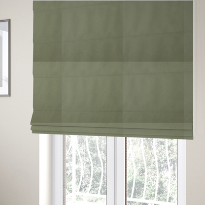 The fabric used to create these Roman blinds is a plain, solid olive green-coloured Hallstatt faux leather fabric texture with a smooth, fine finish.
