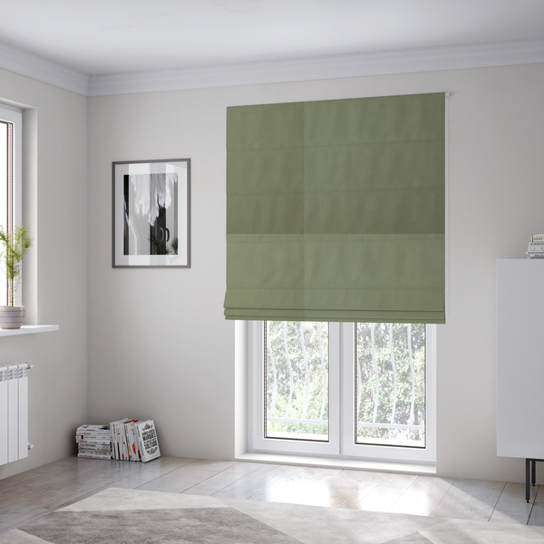 The fabric used to create these Roman blinds is a plain, solid olive green-coloured Hallstatt faux leather fabric texture with a smooth, fine finish.
