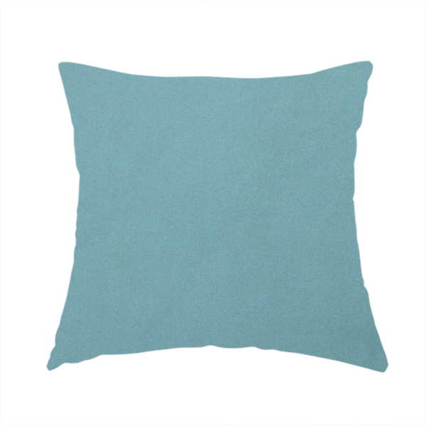 The fabric used to create this handmade cushion is a plain, solid blue-coloured Hallstatt faux leather fabric texture with a smooth, fine finish.