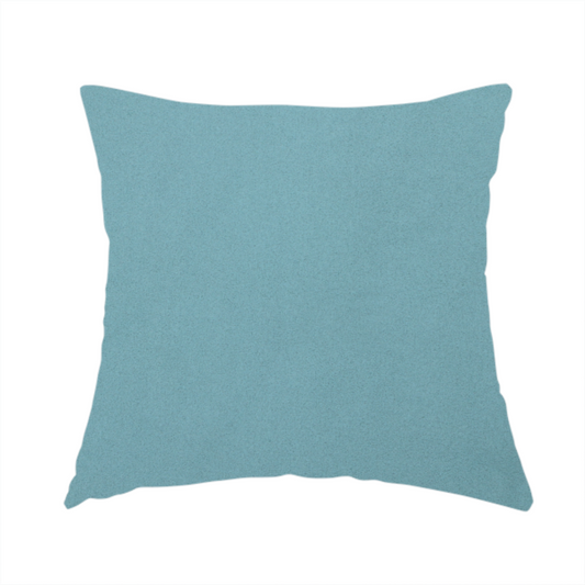 The fabric used to create this handmade cushion is a plain, solid blue-coloured Hallstatt faux leather fabric texture with a smooth, fine finish.
