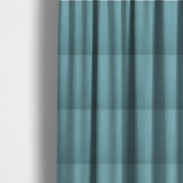 The fabric used to create these made-to-measure curtains is a plain, solid blue-coloured Hallstatt faux leather fabric texture with a smooth, fine finish.