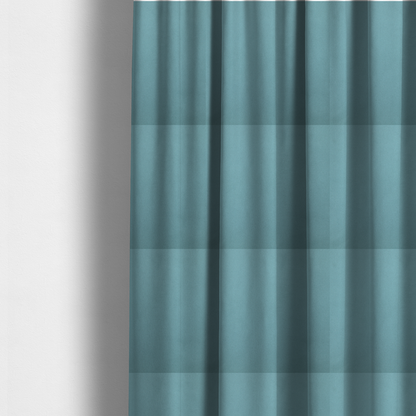 The fabric used to create these made-to-measure curtains is a plain, solid blue-coloured Hallstatt faux leather fabric texture with a smooth, fine finish.