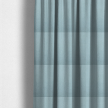 The fabric used to create these made-to-measure curtains is a plain, solid light blue-coloured Hallstatt faux leather fabric texture with a smooth, fine finish.