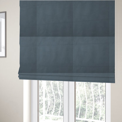 The fabric used to create these Roman blinds is a plain, solid dark blue-coloured Hallstatt faux leather fabric texture with a smooth, fine finish.