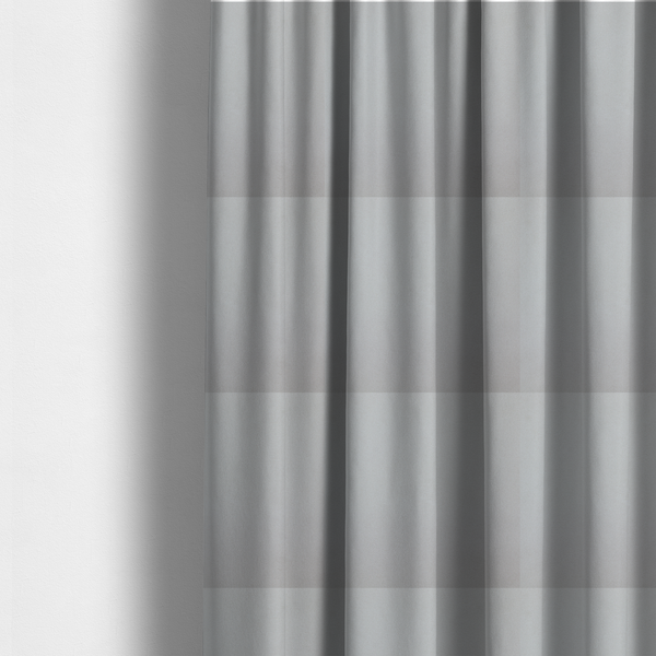 The fabric used to create these made-to-measure curtains is a plain, solid light grey-coloured Hallstatt faux leather fabric texture with a smooth, fine finish.